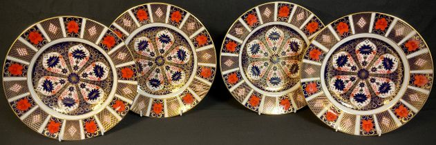 A set of four Royal Crown Derby Imari palette 1128 pattern dinner plates, 27cm diameter, printed
