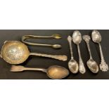 A silver tea strainer, Sheffield 1937; a pair of sugar bows, Sheffield, 1900; silver teaspoons, 139g