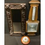 A 19th century Scottish carved oak rectangular mirror, 60cm x 30cm; a Art Deco oak barometer;