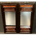 A pair of Chinese mirrors, pierced friezes, brass hanging hooks, 65cm x 28cm