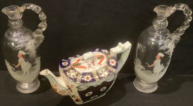 A pair of 19th century Mary Gregory style enamelled clear glass jugs, hand painted; a