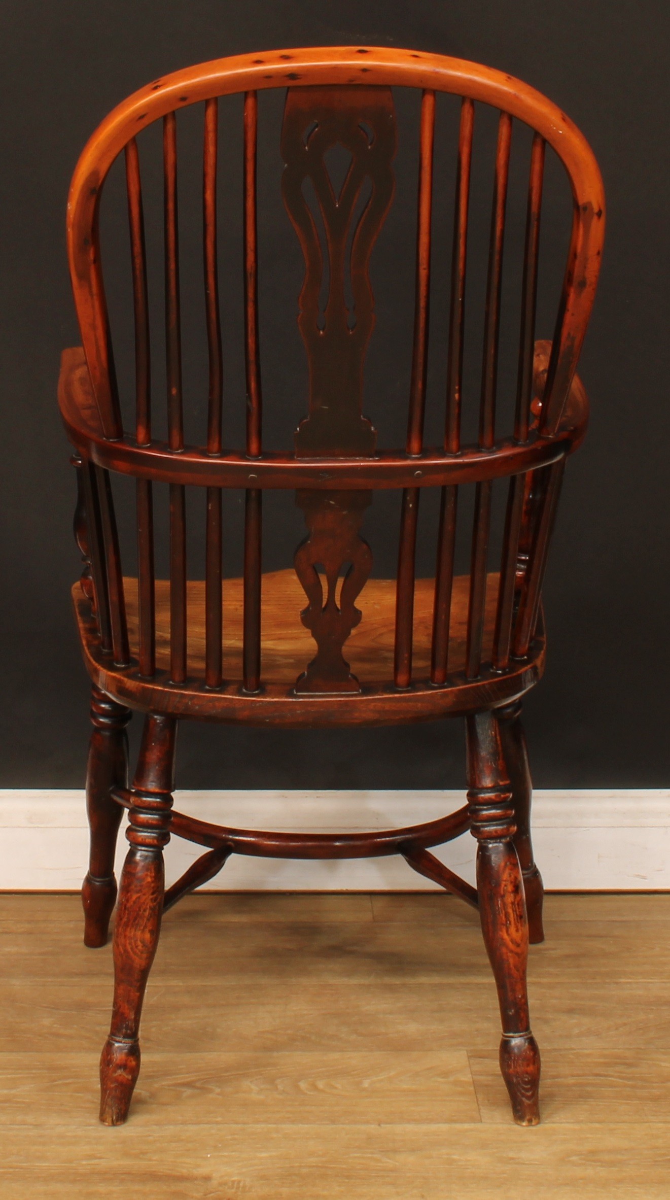 A 19th century yew and elm Windsor elbow chair, hoop back, shaped and pierced splat, one-piece mid- - Image 4 of 4