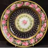 A Royal Crown Derby cabinet plate, painted with roses, gilded blue band, late 19th/early 20th