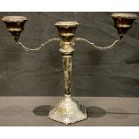 A silver two branch candelabra, hexagonal stepped base, hollow filled, 21.5cm, Birmingham 1963,