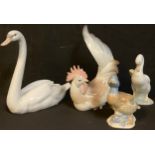 A Lladro model of a cockerel, a Lladro model of a swan; a Nao goose; another bird model (4)