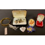 A silver ingot pendant, London 1977; a pair of gold plated silver cuff links; a metal bangle; a