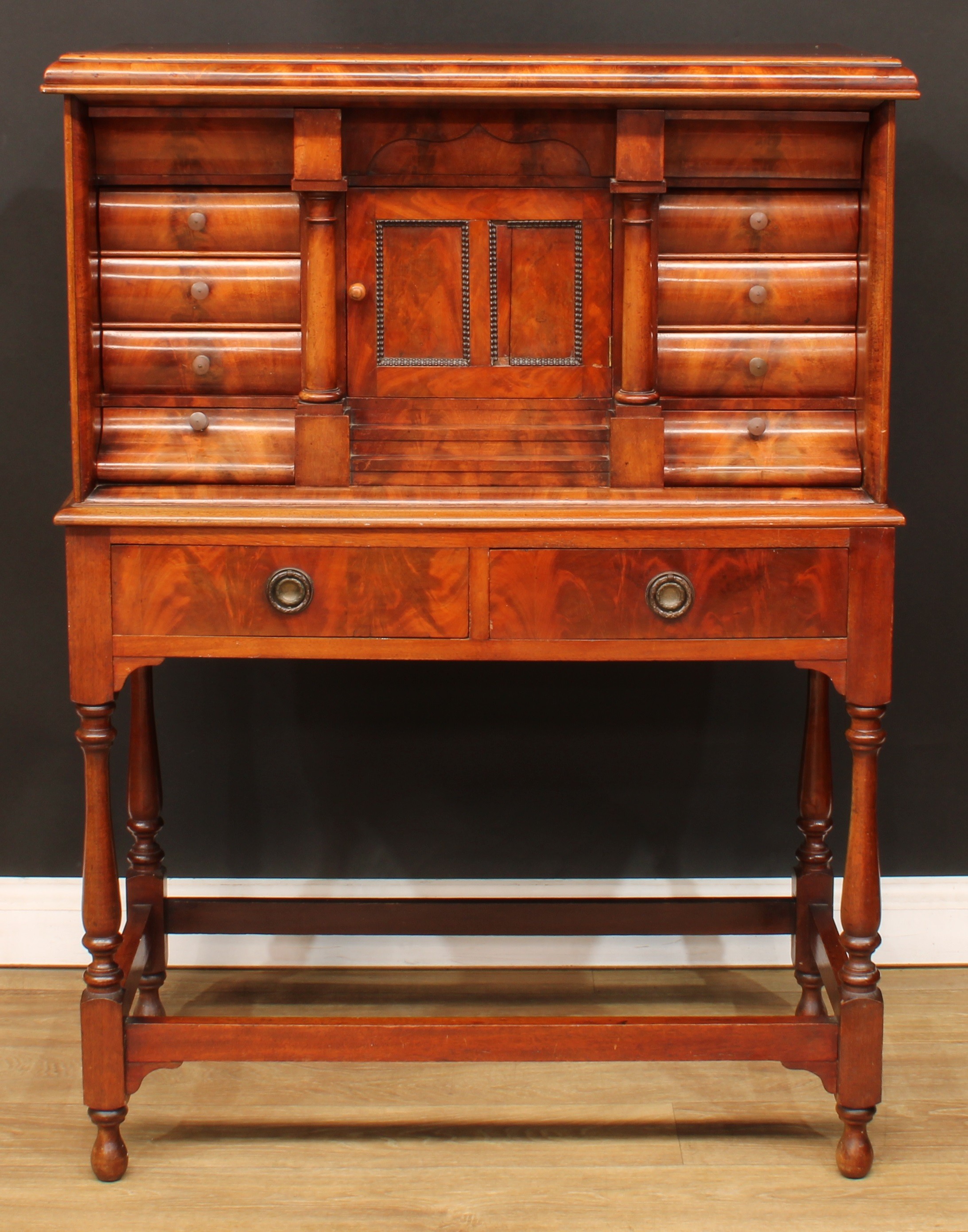 A Biedermeier flame mahogany architectural collector’s cabinet, rectangular top with convex-