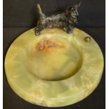 An Art Deco circular onyx dish, mounted with a cold painted bronze terrier playing with a ball, 11.