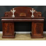 A Victorian mahogany twin-pedestal sideboard, shaped arched back carved with acanthus C and S-