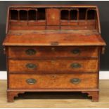 A George III oak bureau, fall front enclosing a small door inlaid with an oval shell patera, small