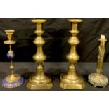 A pair of large Victorian brass ejector candlesticks; a French brass and porcelain candlestick; a