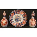 A pair of Japanese gourd shaped bottle vases, a similar Imari palette Japanese plate (3)