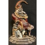 A 19th century cold painted cast iron door stop modelled as Punch with his dog, Toby, 32cm high