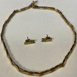 A 9ct gold necklace and earrings suite, marked 375, 19.6g, boxed