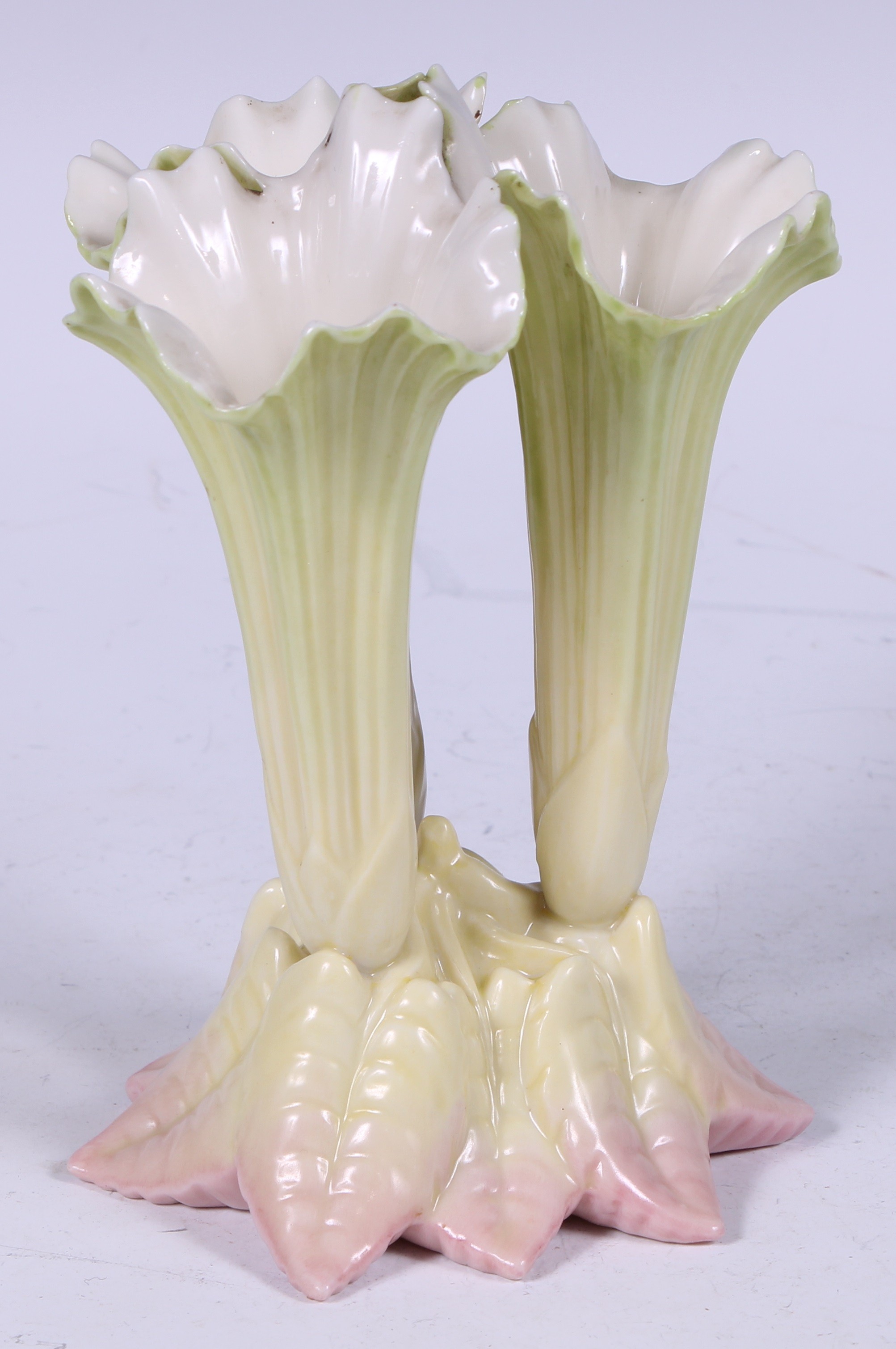 An Edwardian Royal Worcester cluster spill vase, in the form of lily flowers, blush-tipped leaves,