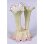 An Edwardian Royal Worcester cluster spill vase, in the form of lily flowers, blush-tipped leaves,