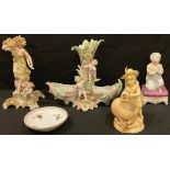 A German porcelain Rudolstadt spill vase, in ivory tones, modelled as a child with a chick and a