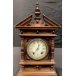 A late 19th century mahogany architectural mantel clock, the arched case with broken swan neck