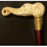 A contemporary carved bone handled walking stick, the handle as the head of an elephant, 88cm long