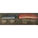 A pair of gold plated spectacles, cased; a pair of steel spectacles, cased (2)