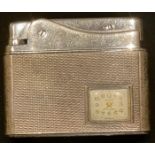 A silver combination purse watch and cigarette lighter