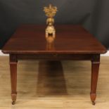 A late Victorian mahogany extending dining table, rounded rectangular top with two additional