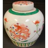 A Chinese ginger jar and cover, painted with dragons chasing the flaming pearl and phoenix, green