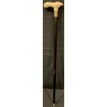 A contemporary carved bone handled walking stick, the handle as as a stylised bird, 90.5cm long