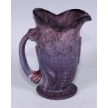 A late 19th century pressed slag glass jug or vase, modelled in the form of a fish, the tail formed