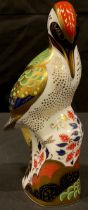 A Royal Crown Derby paperweight, Green Woodpecker, gold stopper, 17.5cm, printed marks in red