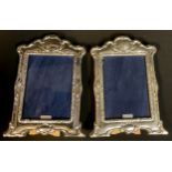 A pair of contemporary Art Nouveau style hallmarked silver photograph frames, wooden easel backs,