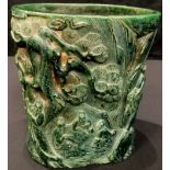 A large contemporary Chinese carved green stone effect brush pot, decorated with figural