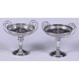 An associated pair of silver pedestal sweetmeat dishes, Walker & Hall, Sheffield, 1908 and 1912, 12c