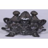 An Art Nouveau pewter inkstand or double inkwell, cast with flower heads and whiplash stems, 16.