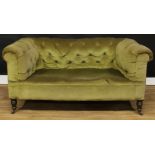 A Victorian Chesterfield sofa, stuffed-over deep button upholstery, turned forelegs, ceramic