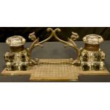 A late 19th century brass desk stand, complete with a pair of cut glass ink wells and hinged covers,