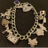 A hallmarked silver charm bracelet with padlock and thirteen charms