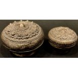 A Tibetan/Nepalese silver coloured metal box and cover; another (2)