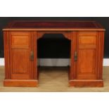 A late Victorian walnut desk, rectangular top with inset tooled and gilt writing surface above a