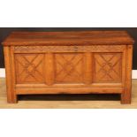 An 18th century and later oak blanket chest, hinged top above a blind fretwork frieze and a three