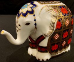 A Royal Crown Derby paperweight, Elephant, printed in the 1128 palette, trunk raised, gold