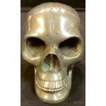A cast metal model of a human skull, with articulated lower jaw, 9.5cm high