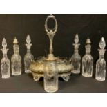A Victorian silver plated seven bottle cruet stand, embossed with foliate scrolls, original
