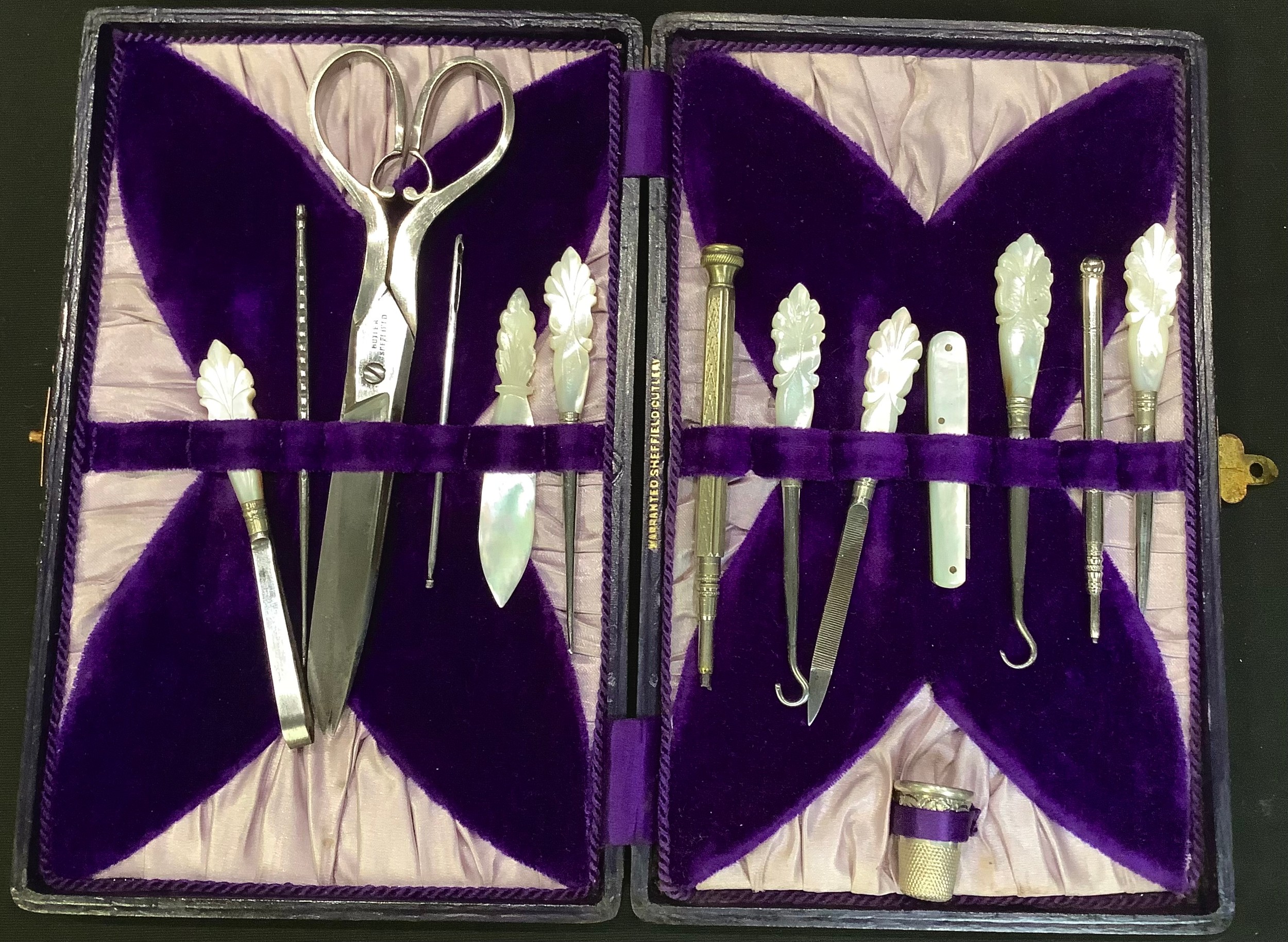 A comprehensive Victorian cased sewing set, mother of pearl handles