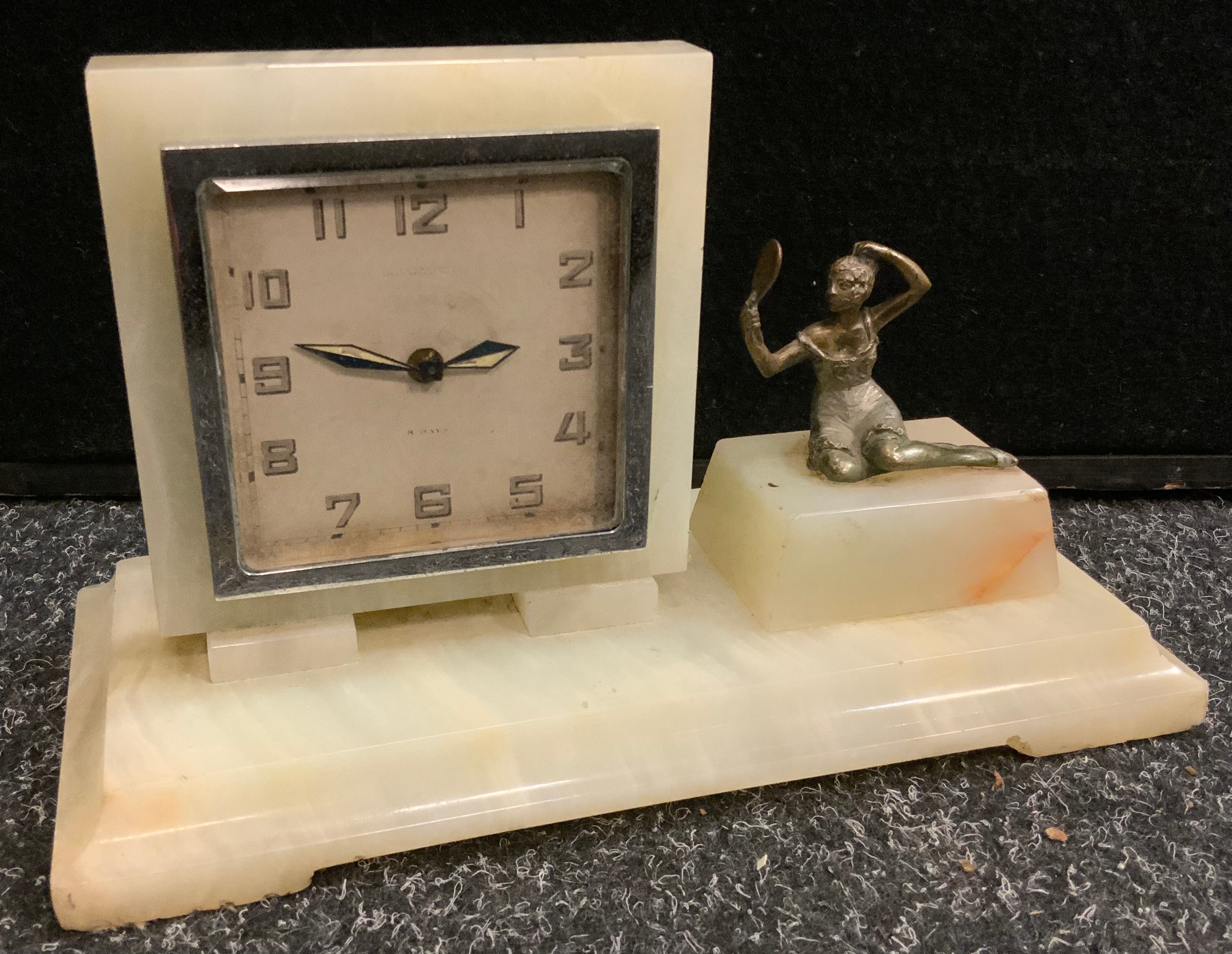 An Art Deco onyx rectangular clock, the square dial with Arabic numerals, the rectangular base