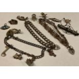 A Scottish silver and hardstone bar brooch; a silver gate bracelet; two silver charm bracelets, with