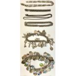A silver curb link charm bracelet, assorted charms including London Bridge, tennis racquet,