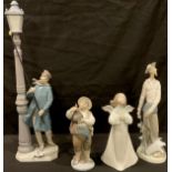 A Lladro figure, The Lamp Lighter, 48cm, printed marks; three others smaller, Don Quixote, Sancho