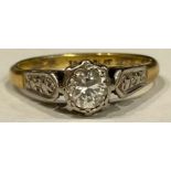 An 18ct gold diamond solitaire ring, platinum bezel