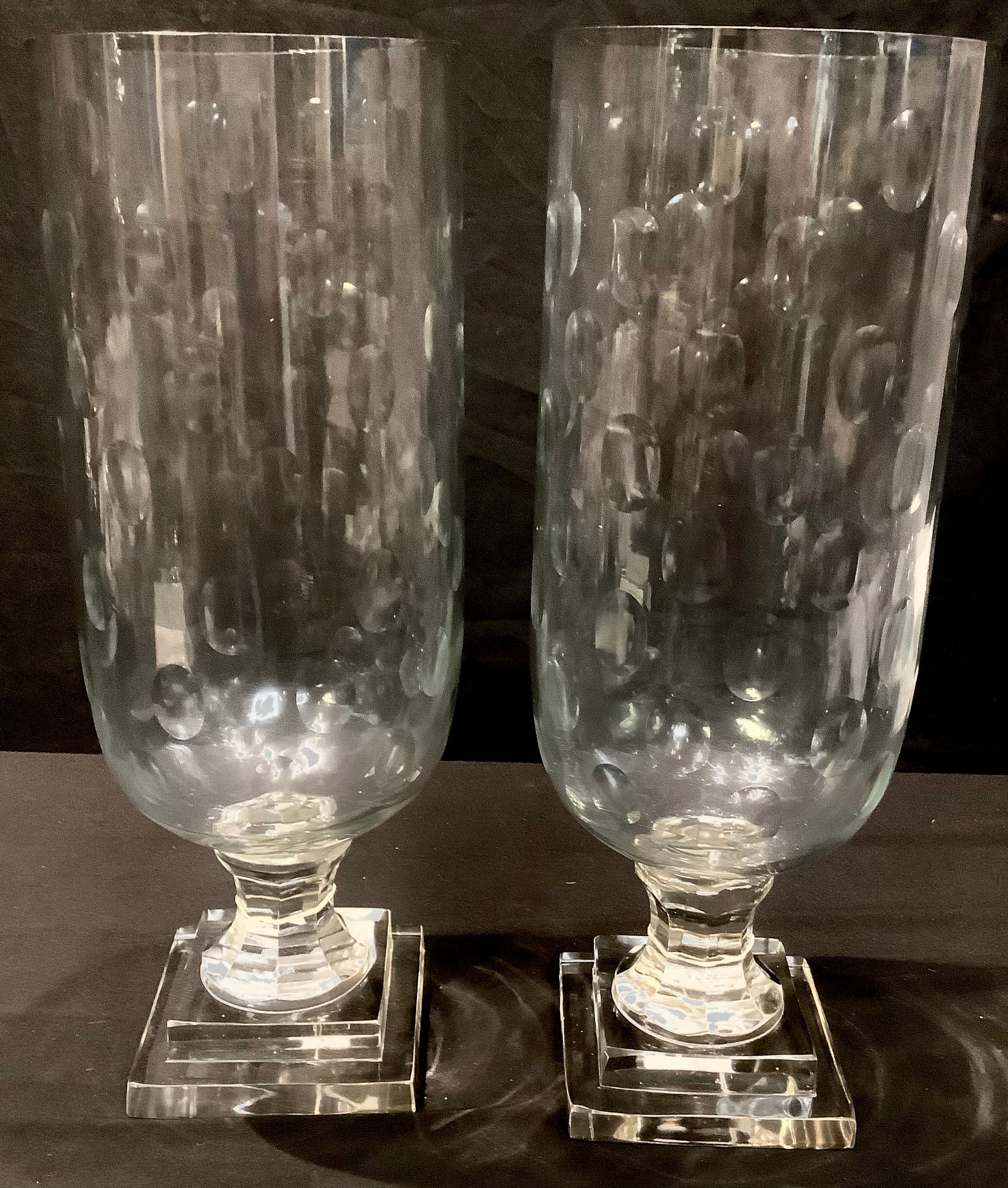 A large pair of reproduction Victorian style glass storm lamps, stepped bases, approx. 40cm high